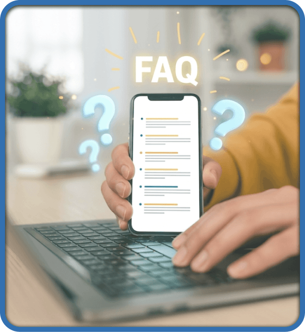 Student using a laptop while holding a phone displaying an FAQ