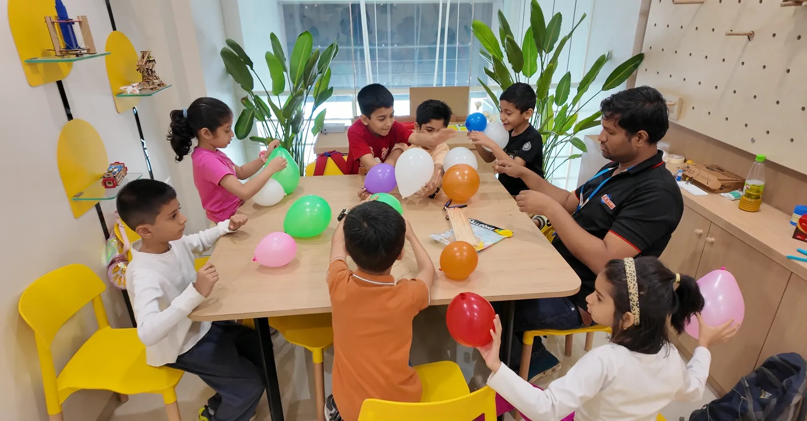 Children inflating balloons in a Robokidz hands-on science workshop